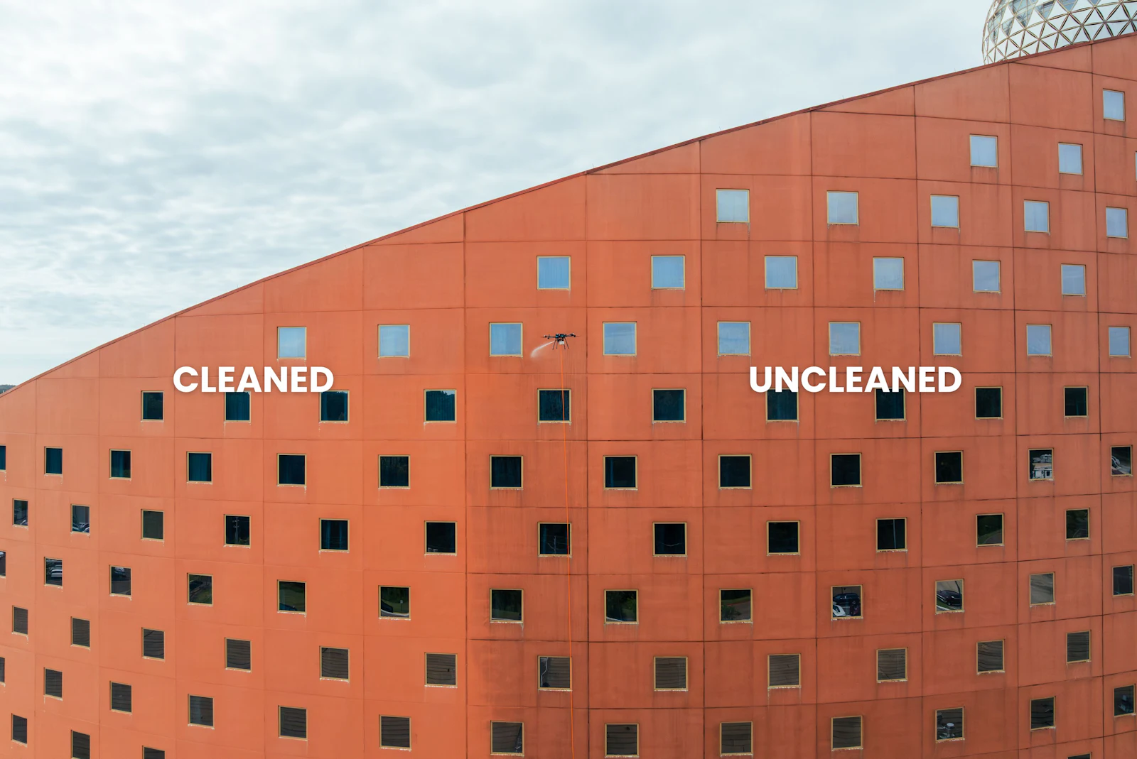 Close-up of a building wall where the cleaned section meets the uncleaned section